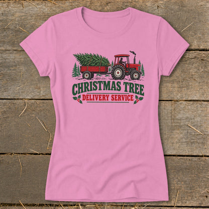 Pink t-shirt with red tractor pulling a Christmas tree trailer and text.