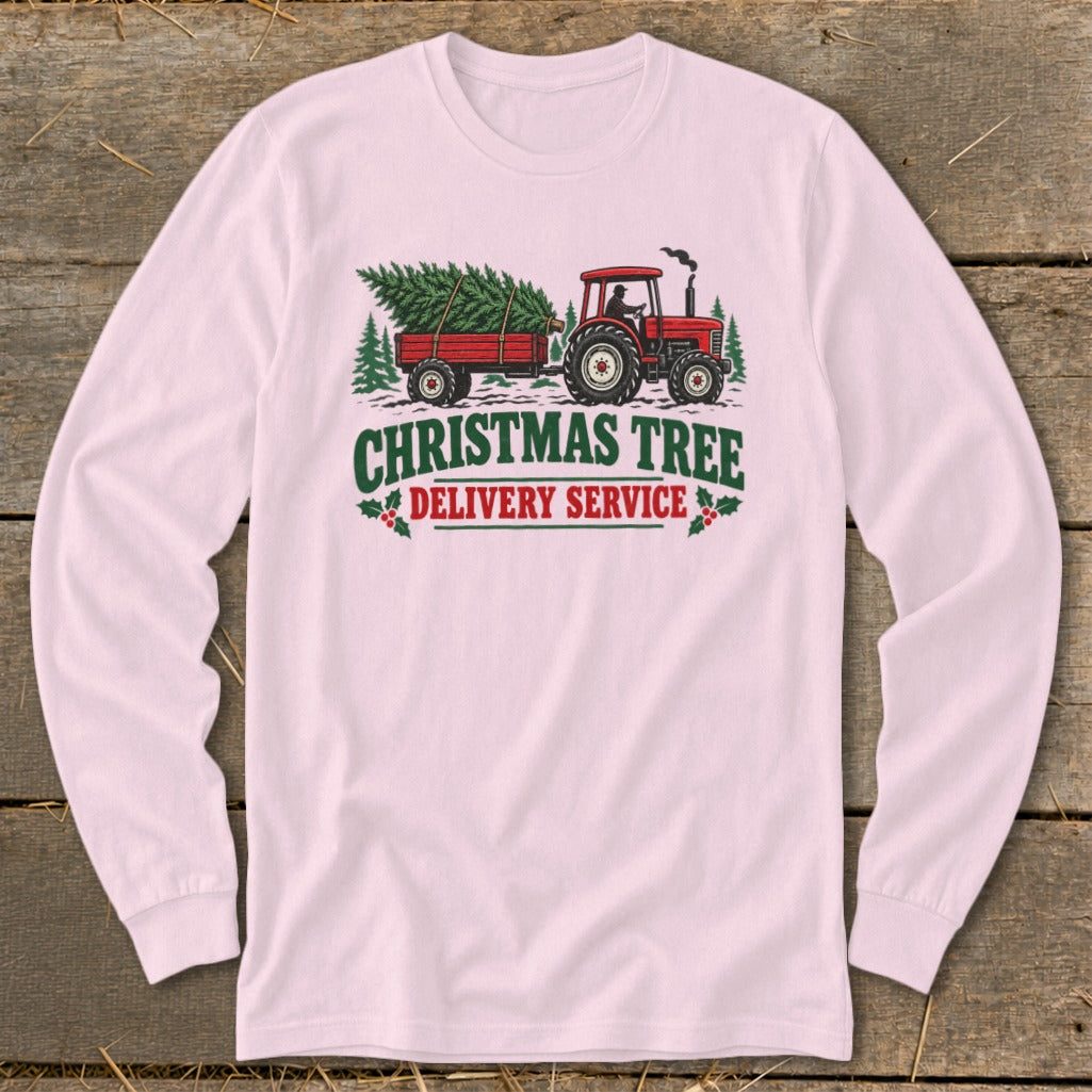 Tractor pulling trailer with Christmas tree, says "Christmas Tree Delivery Service".