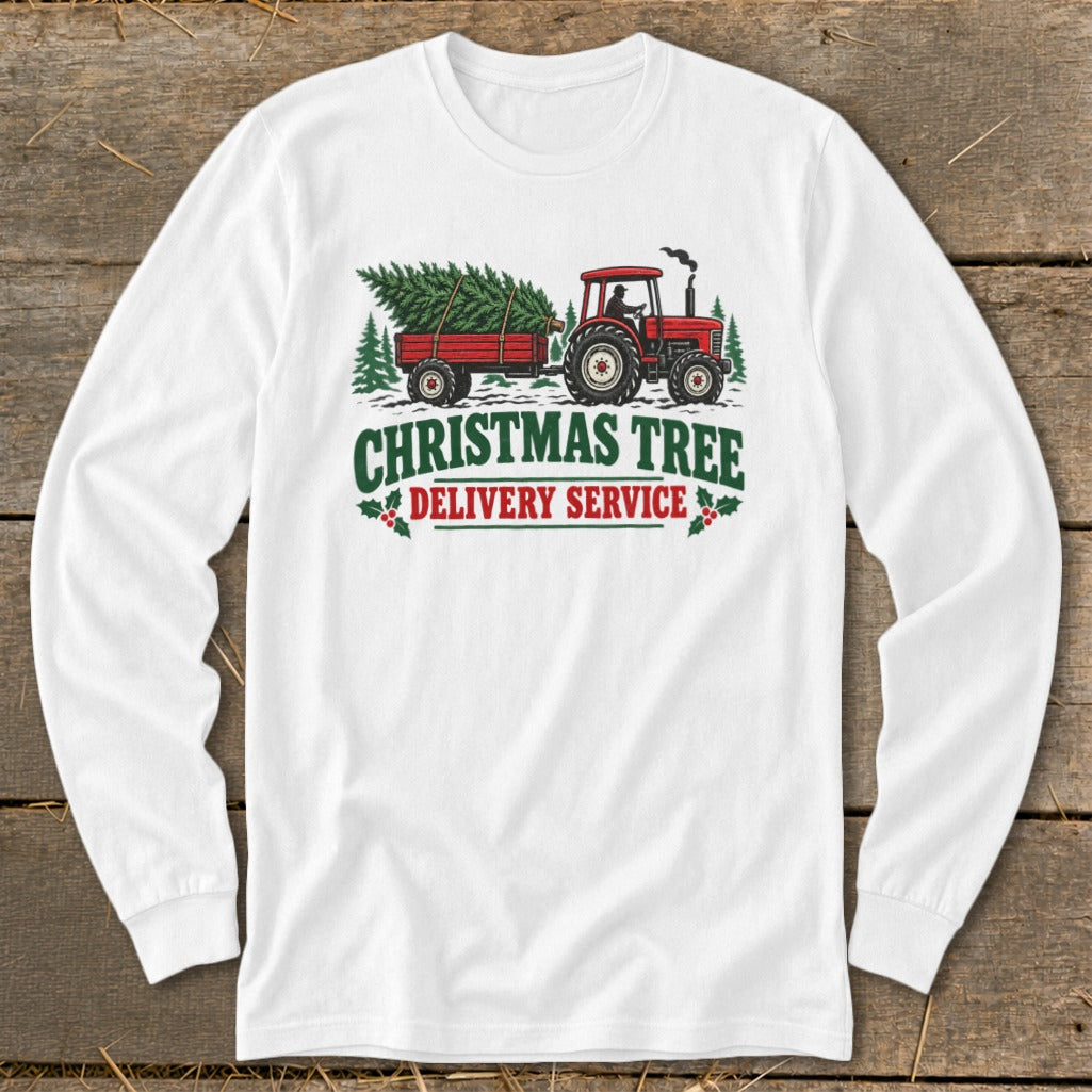 White long sleeve shirt with red tractor hauling Christmas tree, "Christmas Tree Delivery Service" text.