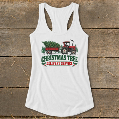 White tank top with "Christmas Tree Delivery Service" graphic featuring a tractor towing a tree.