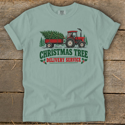 Red tractor pulling a trailer with a Christmas tree, text "Christmas Tree Delivery Service".
