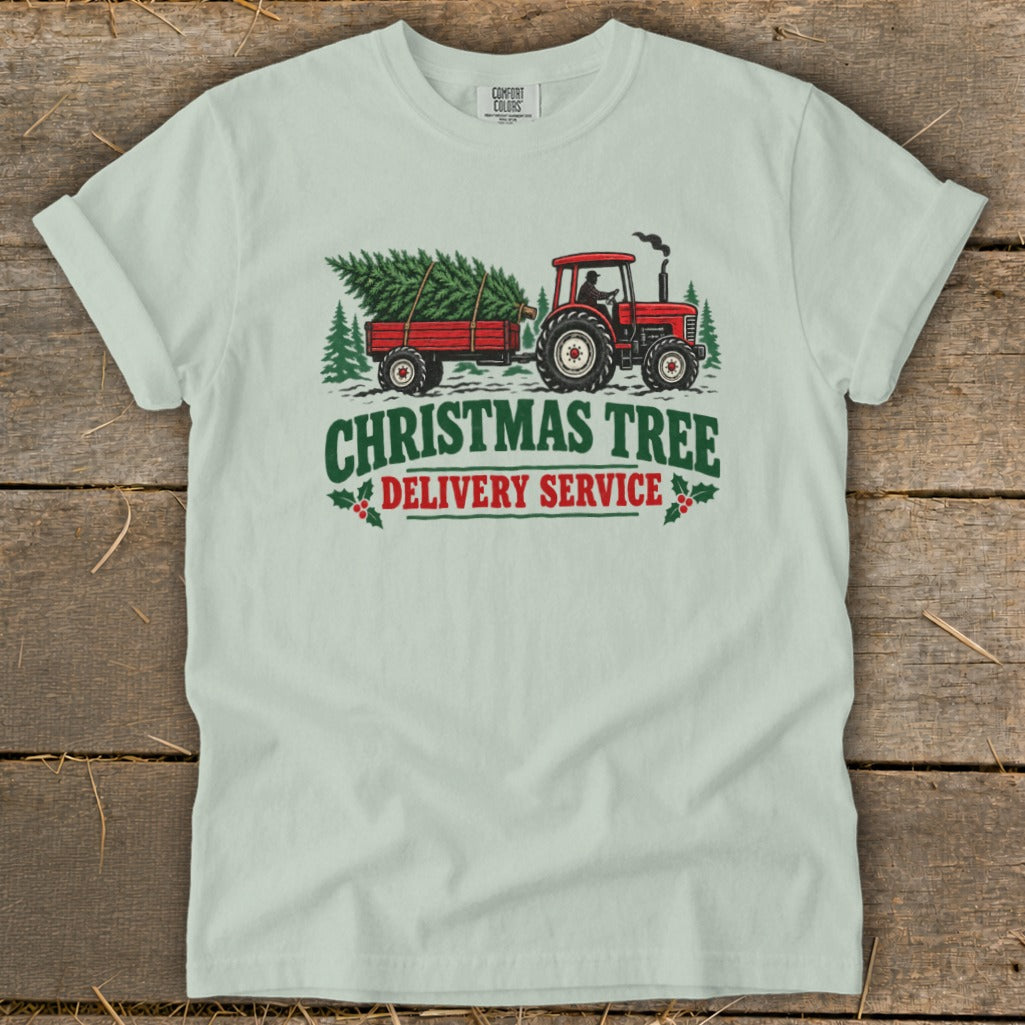Red tractor pulling a Christmas tree trailer with text "Christmas Tree Delivery Service".
