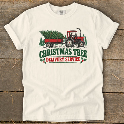 Tractor and trailer carrying Christmas trees with "Christmas Tree Delivery Service" text.
