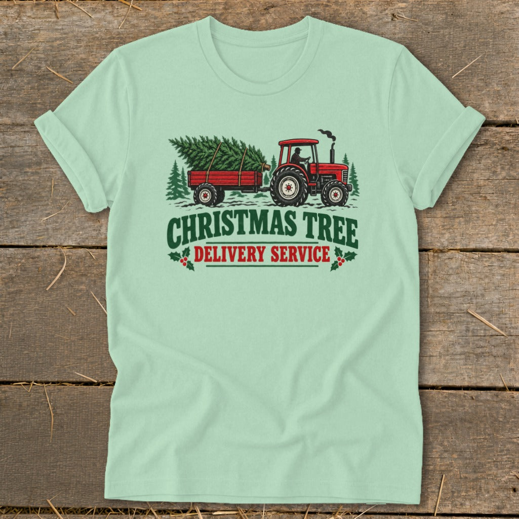 Red tractor pulling trailer with Christmas tree, text reads "Christmas Tree Delivery Service".