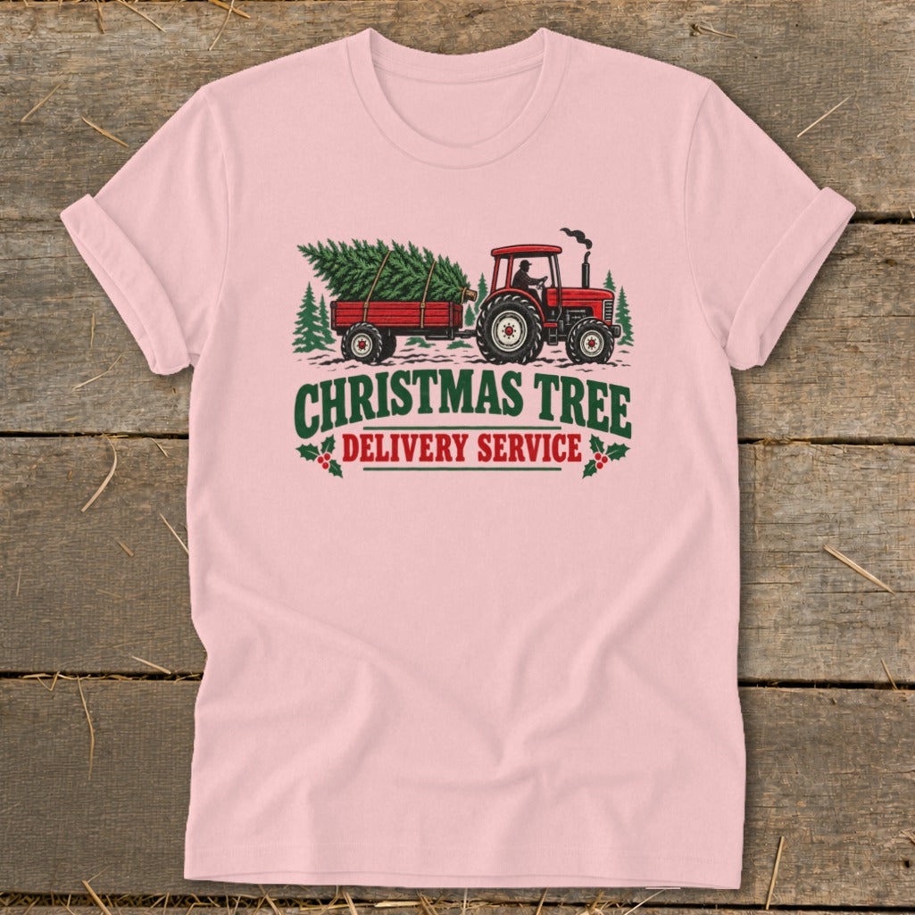 Pink t-shirt with red tractor towing a Christmas tree, text "CHRISTMAS TREE DELIVERY SERVICE".