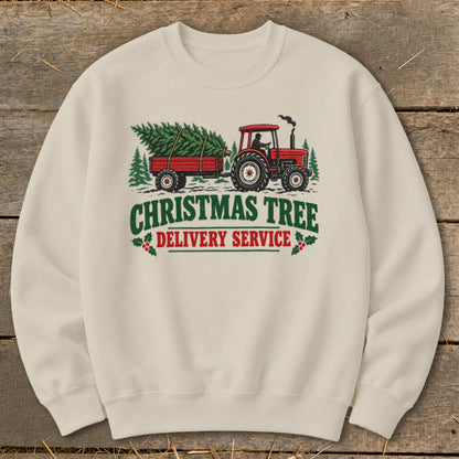 Cream sweatshirt with red tractor towing a Christmas tree, reading "Christmas Tree Delivery Service".