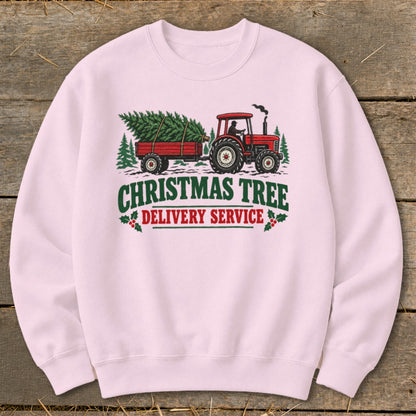 Pink sweatshirt with a red tractor pulling a trailer of Christmas trees and text.