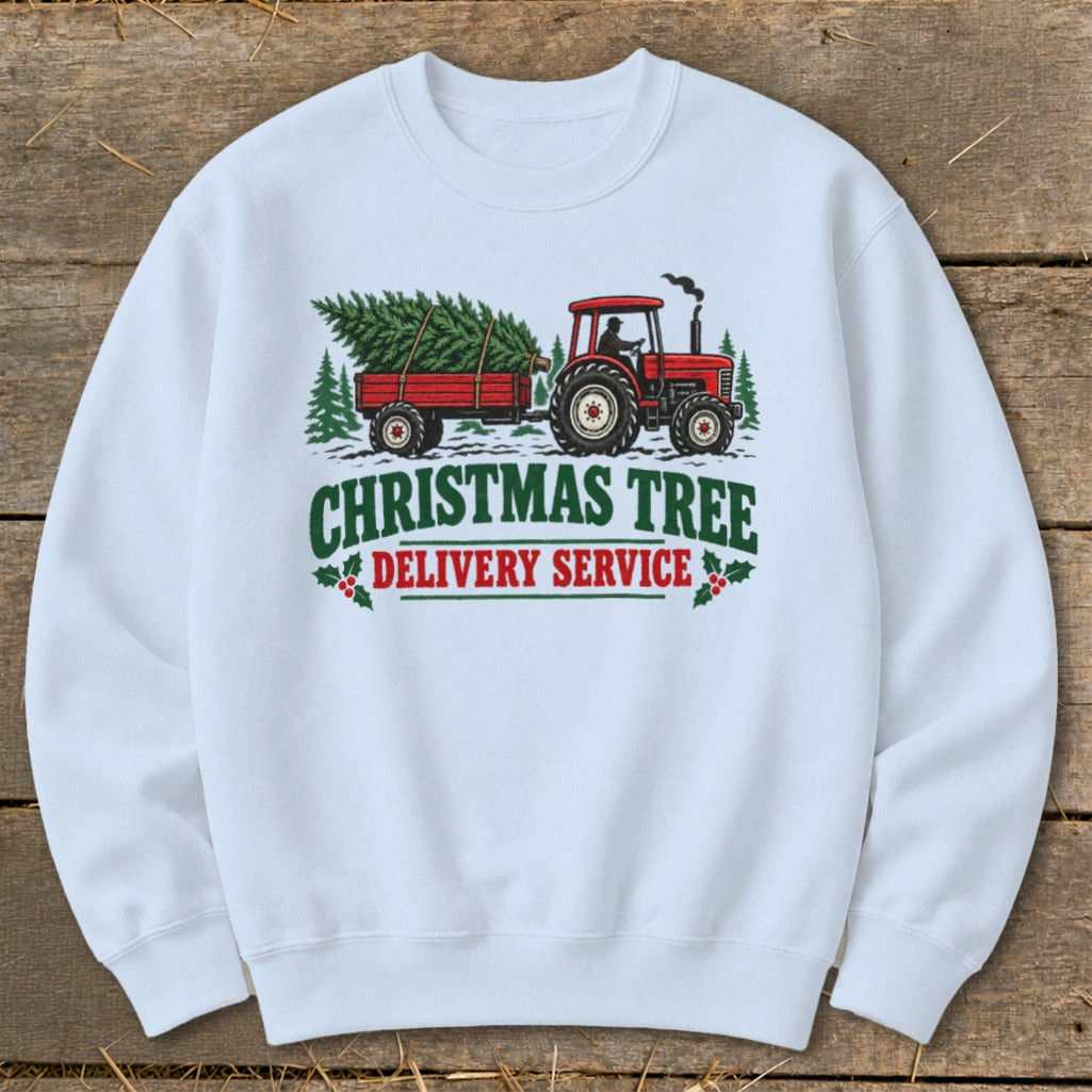 White sweatshirt with Christmas Tree Delivery Service graphic featuring a red tractor and trailer.