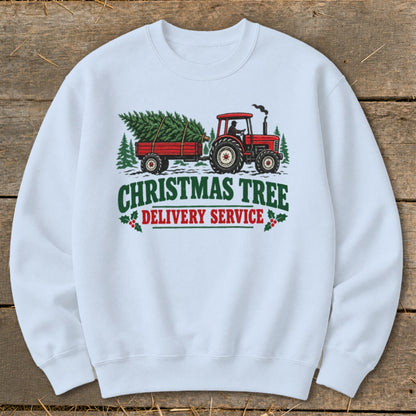 White sweatshirt with Christmas Tree Delivery Service graphic featuring a red tractor and trailer.