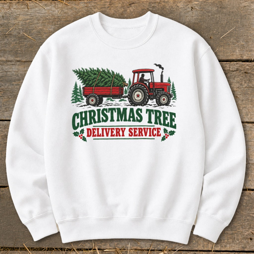 Red tractor pulling trailer with Christmas tree, text reads "Christmas Tree Delivery Service".