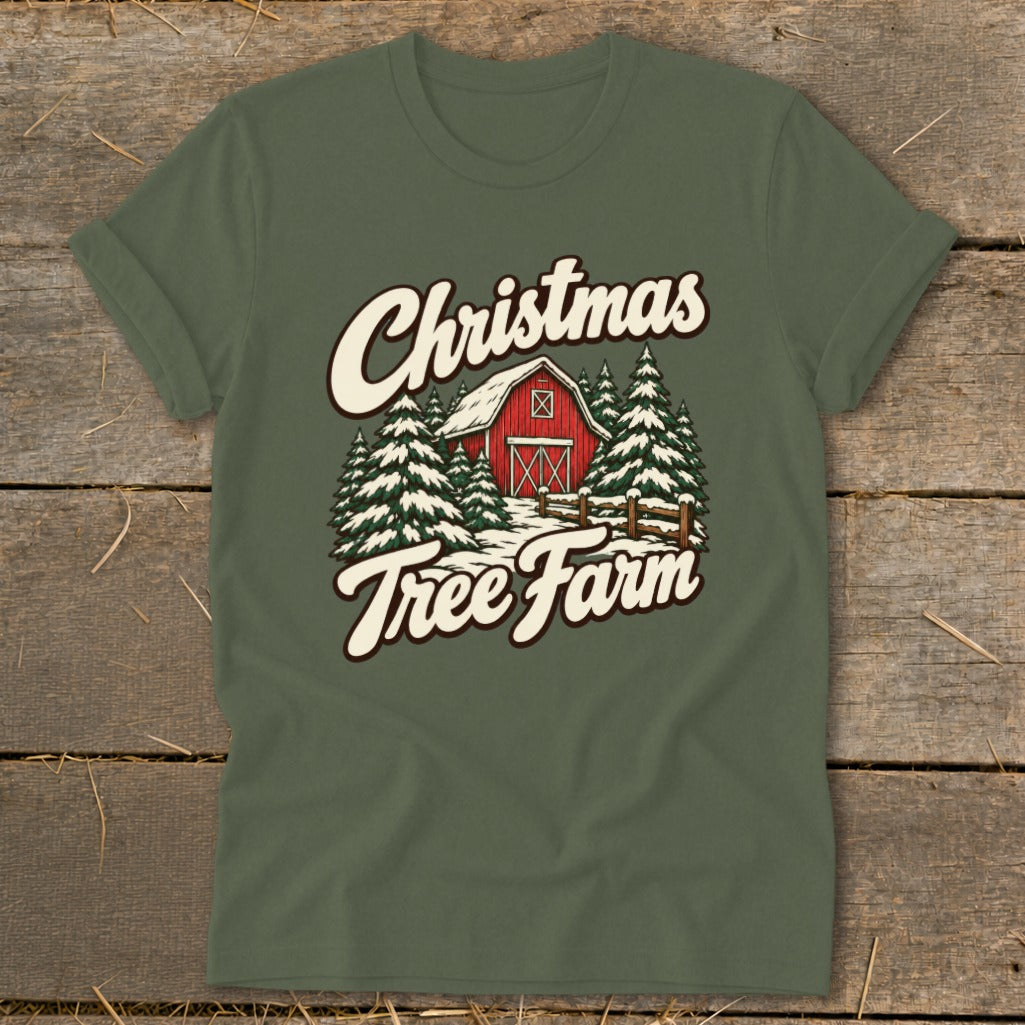 Green t-shirt with a Christmas Tree Farm graphic featuring a red barn and snow-covered pines.