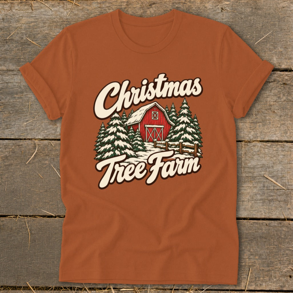 Orange t-shirt with "Christmas Tree Farm" text over a snowy barn and pine trees.