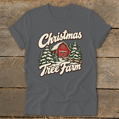 Christmas Tree Farm graphic on a grey t-shirt with a red barn and snow-covered trees.