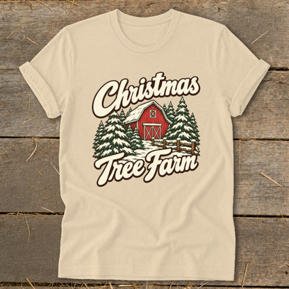 Light-colored t-shirt with "Christmas Tree Farm" graphic featuring a red barn and snow-covered trees.