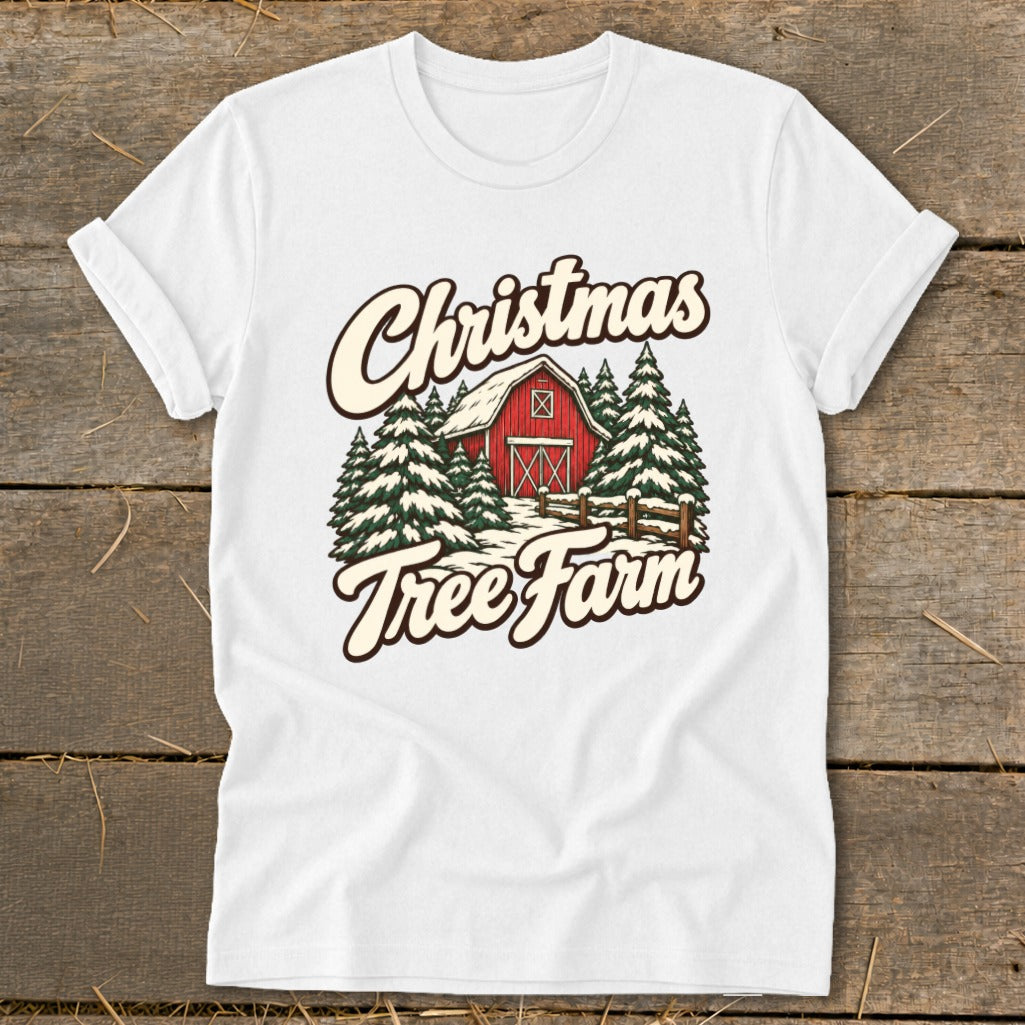 White t-shirt with Christmas Tree Farm graphic featuring red barn and snow-covered pines.