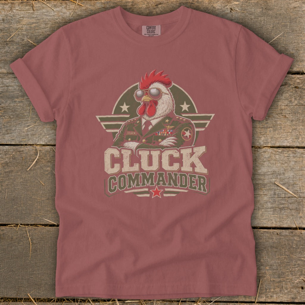 Muted red t-shirt featuring a graphic of a rooster in a military uniform with the text Cluck Commander.