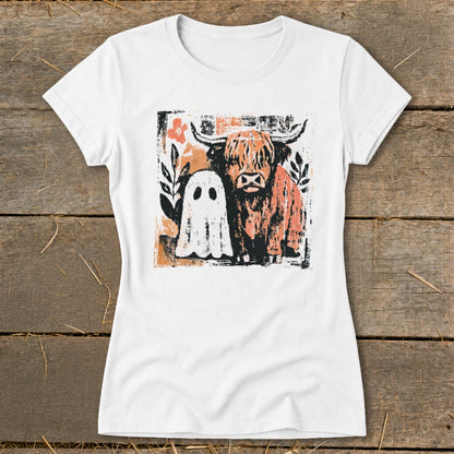 White t-shirt graphic of a Highland cow and a ghost surrounded by floral elements.