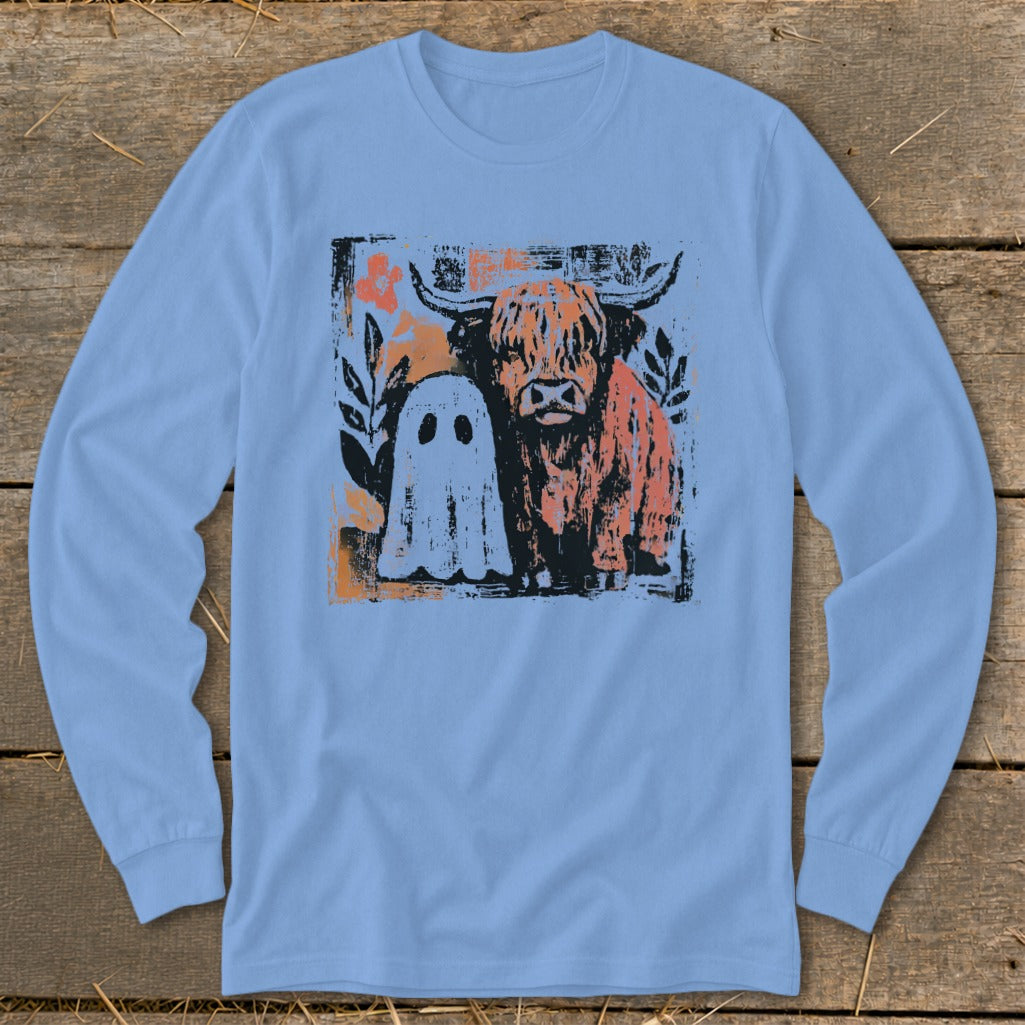 Highland cow and ghost graphic print on a light blue long-sleeved shirt.