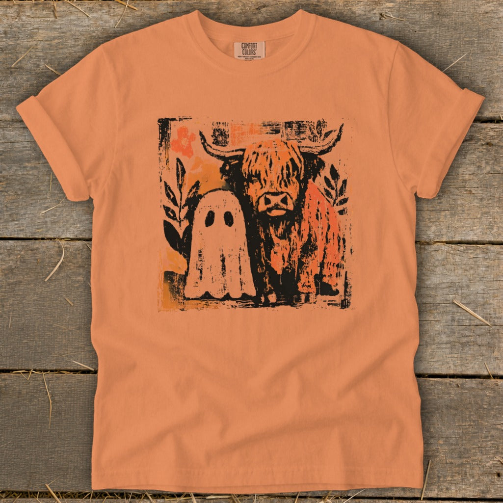 Orange t-shirt with a distressed graphic of a Highland cow and a ghost.