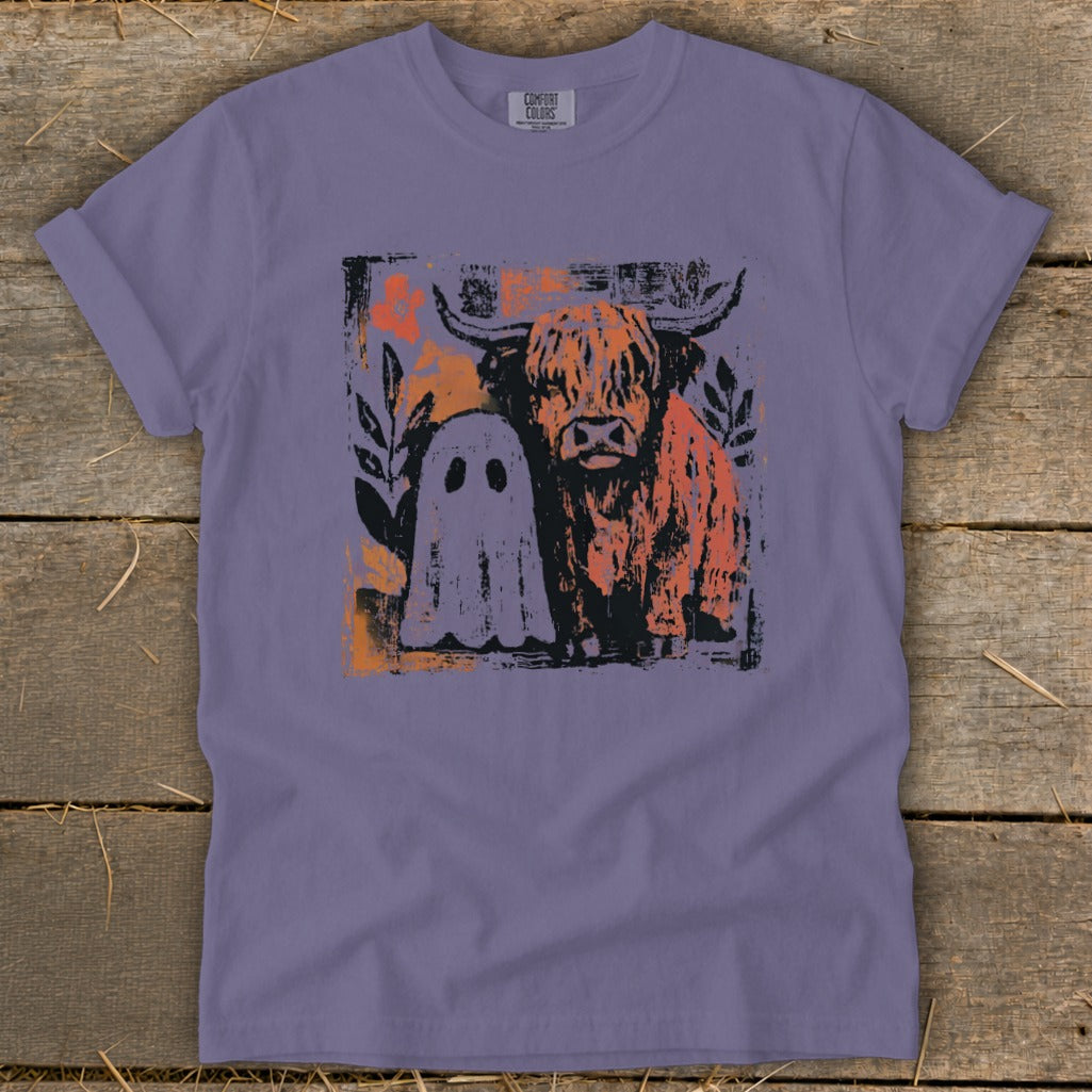 Lavender t-shirt with highland cow and ghost graphic and "COMFORT COLORS" tag.