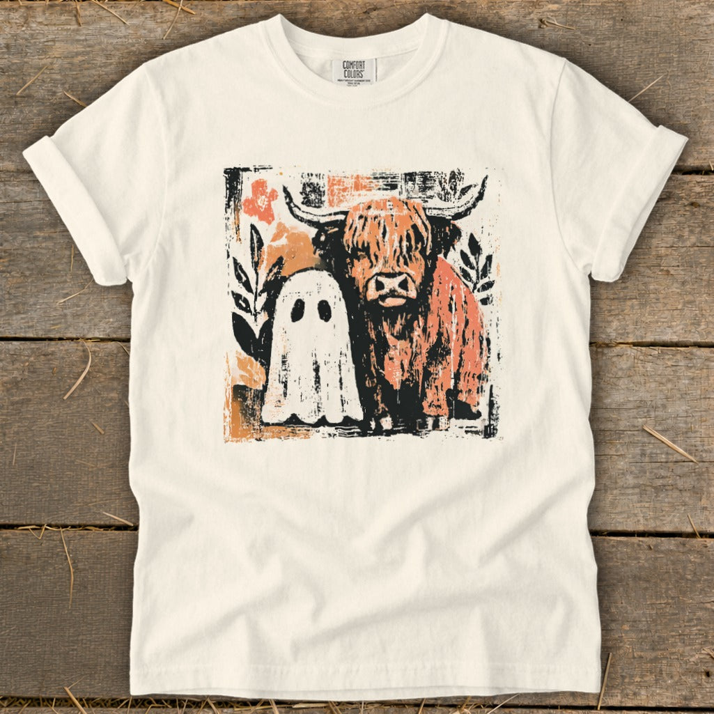 Cream t-shirt with Highland cow and ghost graphic, Comfort Colors tag.