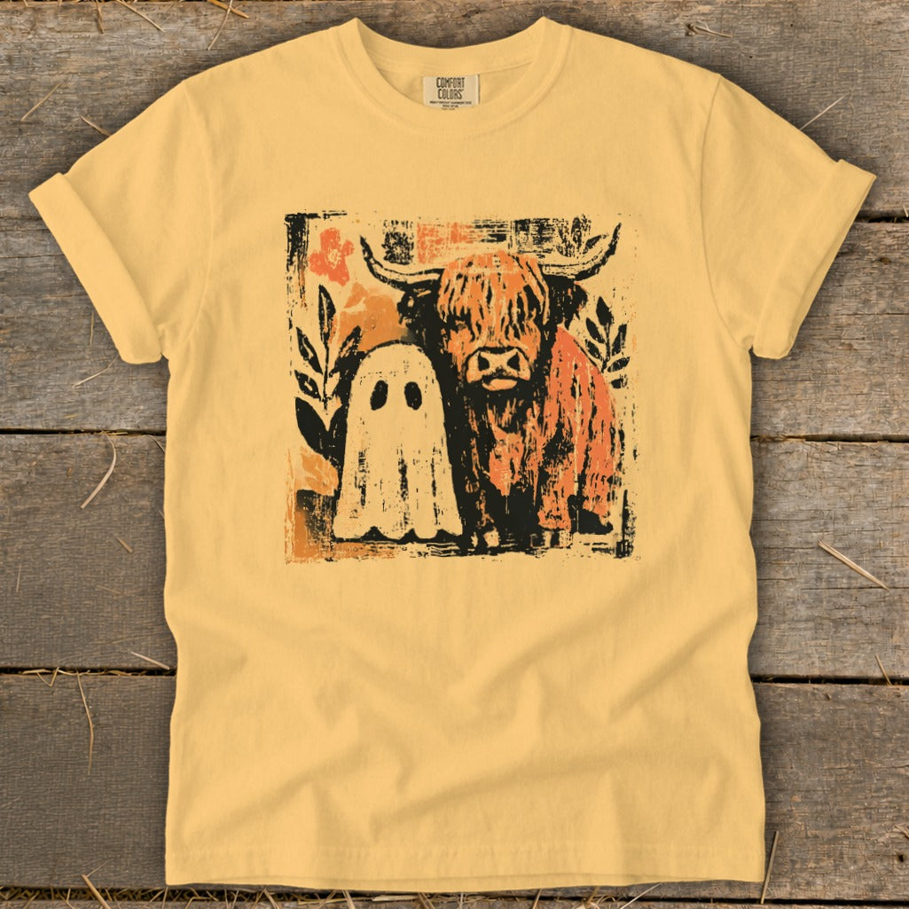 Yellow t-shirt with distressed graphic of a ghost and a Highland cow.