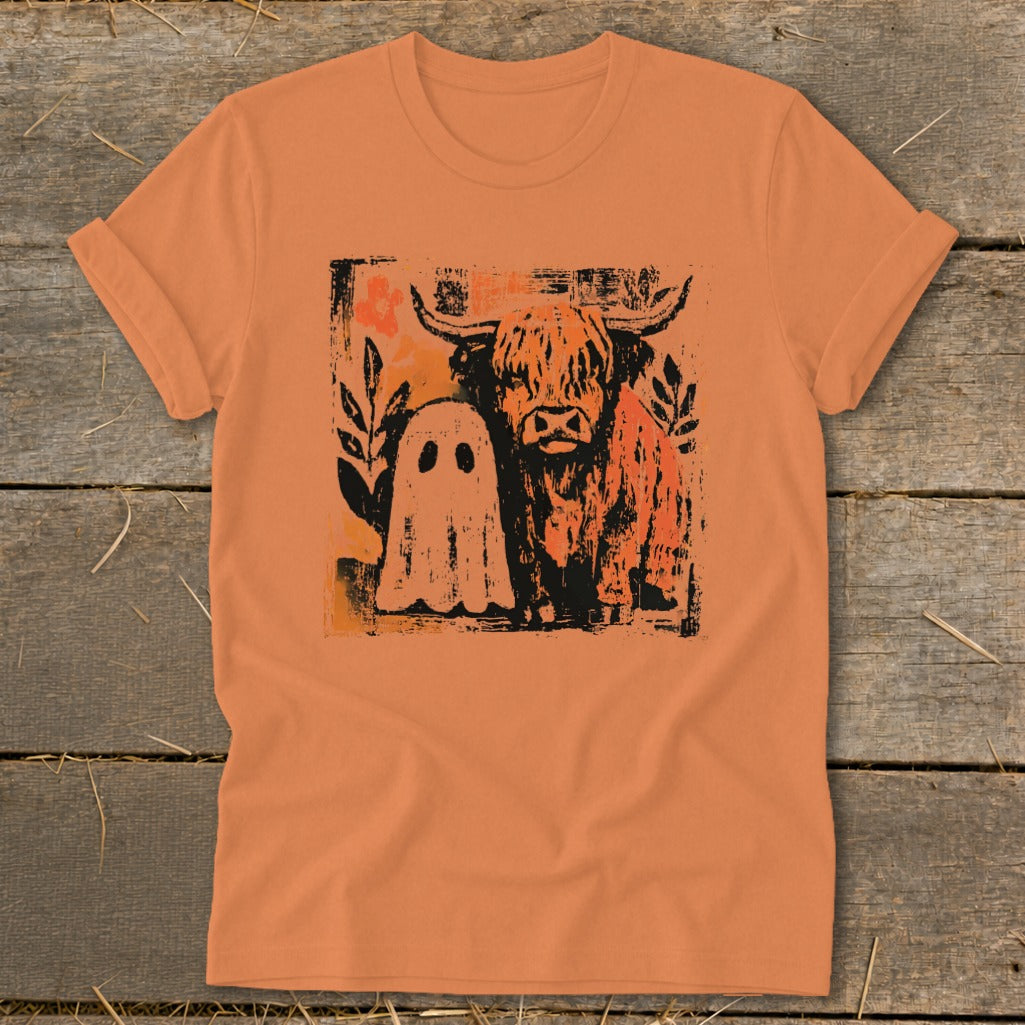 Orange t-shirt with a distressed print of a Highland cow and a ghost.