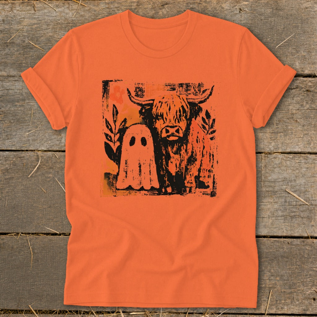 Orange t-shirt with black graphic of Highland cow and friendly ghost.