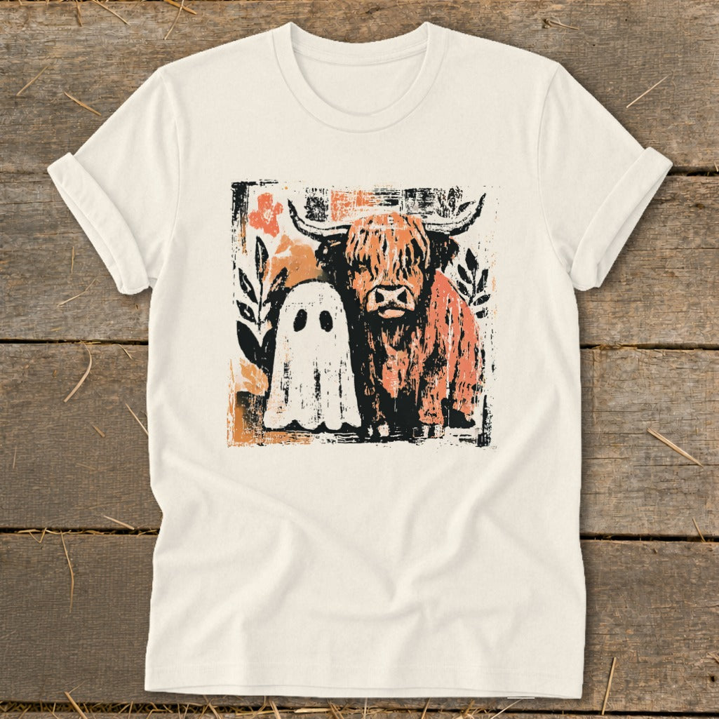 Highland cow and ghost graphic on a cream t-shirt.