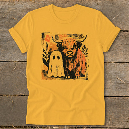 Yellow t-shirt with a graphic of a Highland cow and a ghost.