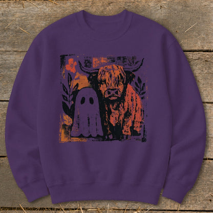 Purple sweatshirt with Highland cow and ghost Halloween graphic.