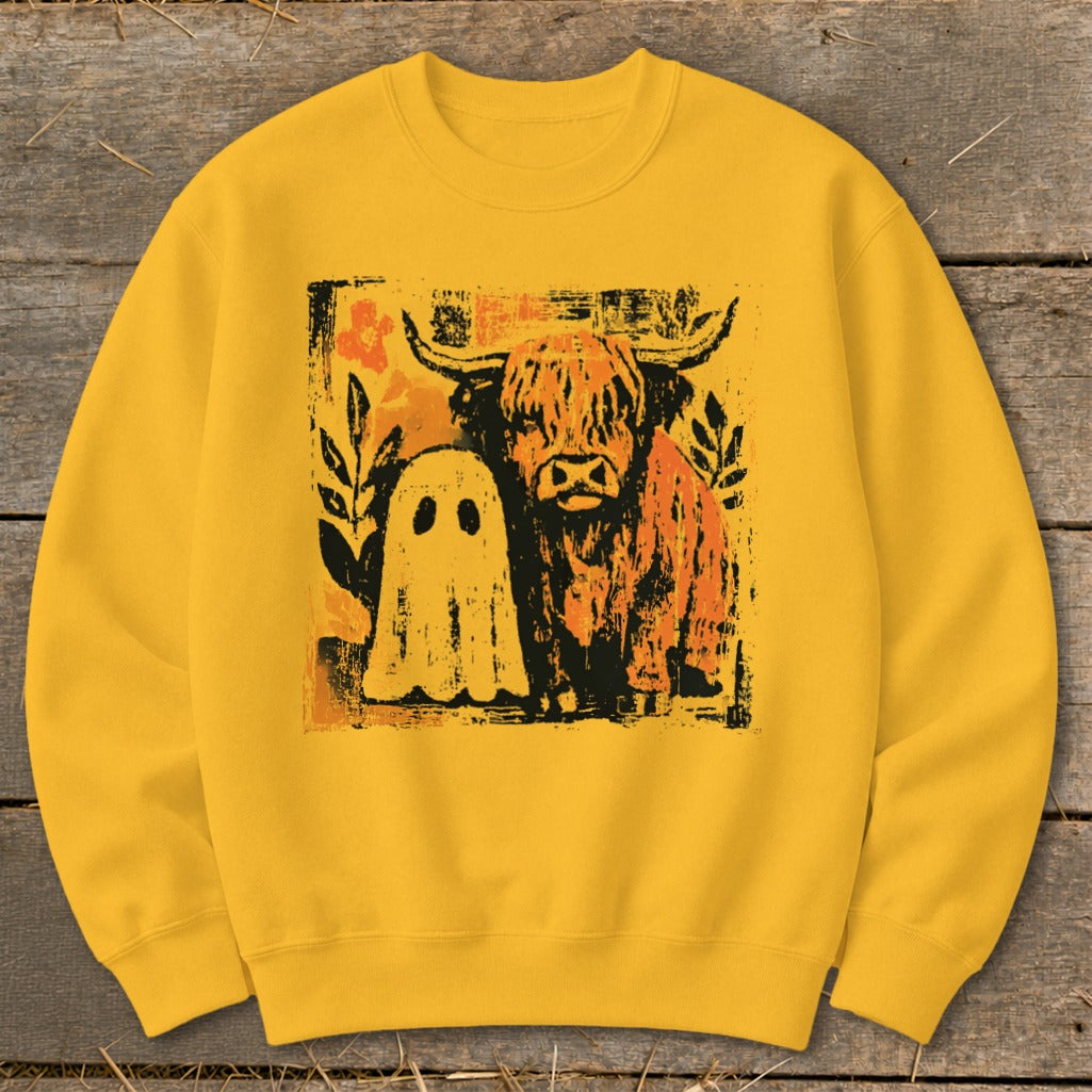Yellow sweatshirt with a distressed graphic of a Highland cow and a ghost.