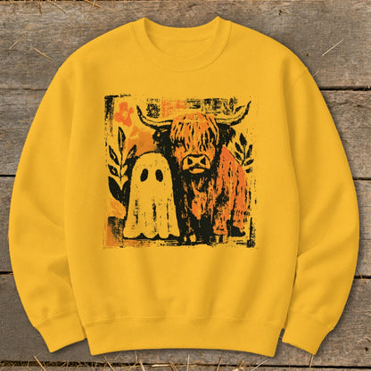 Yellow sweatshirt with a distressed graphic of a Highland cow and a ghost.