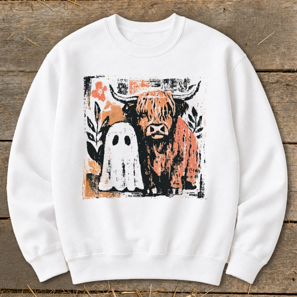 White sweatshirt with a distressed graphic of a Highland cow and a friendly ghost.