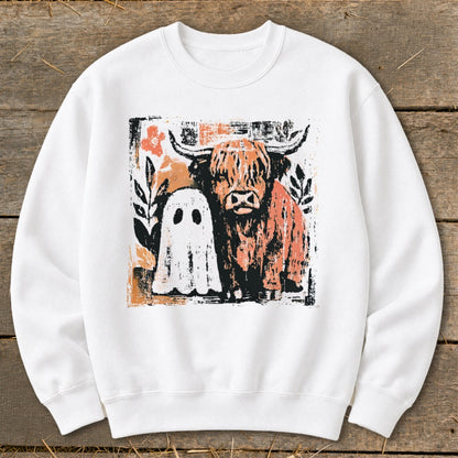 White sweatshirt with a distressed graphic of a Highland cow and a friendly ghost.