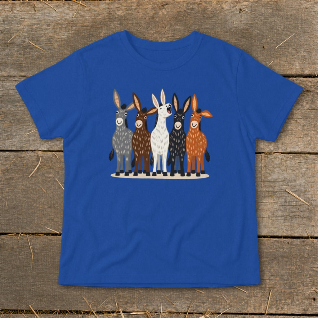 A royal blue t-shirt printed with five illustrated donkeys standing in a row on a wooden background.