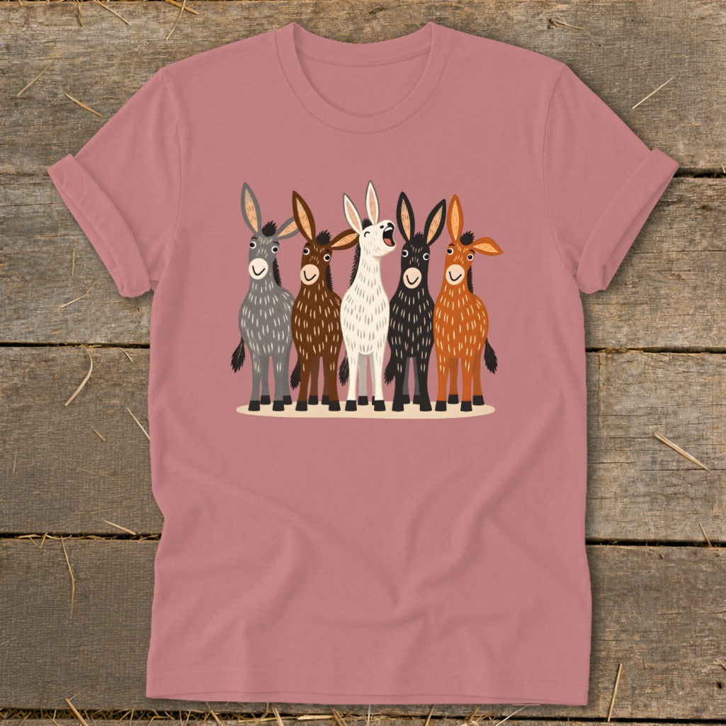 A dusty pink short-sleeve t-shirt featuring a colorful graphic of five illustrated donkeys standing together.