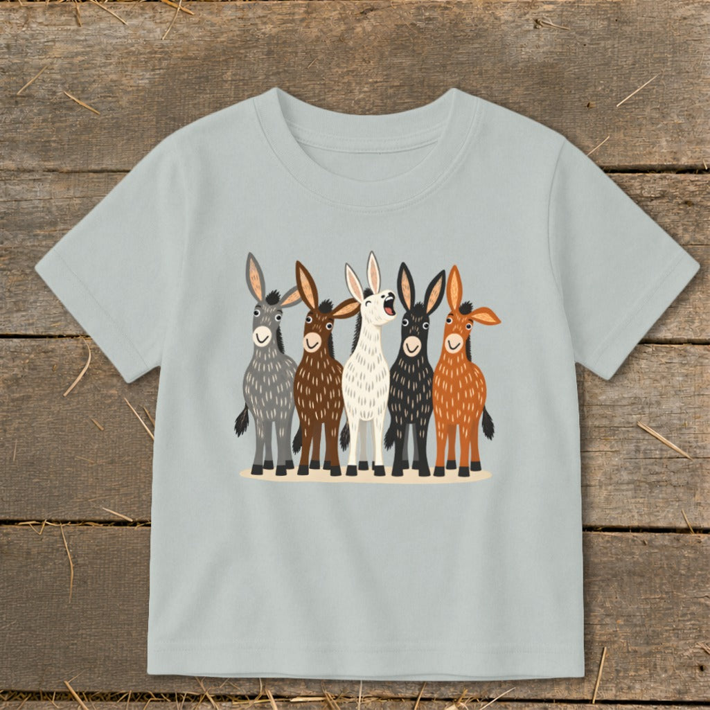 A light gray children's t-shirt features a colorful graphic of five donkeys standing together.