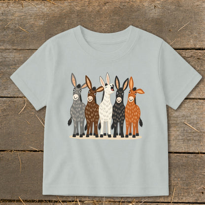 A light gray children's t-shirt features a colorful graphic of five donkeys standing together.