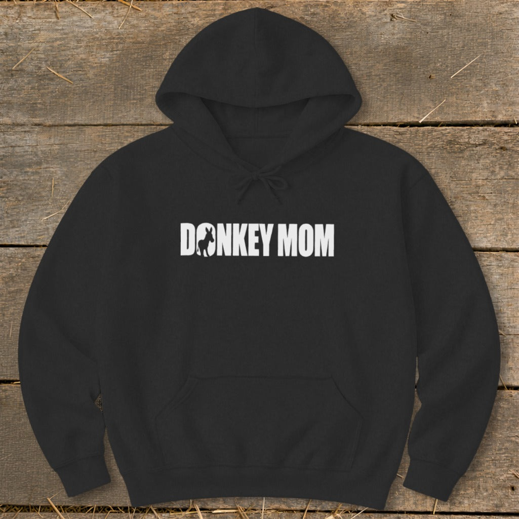 A black hooded sweatshirt with white text reading DONKEY MOM featuring a silhouette of a donkey inside the letter O.