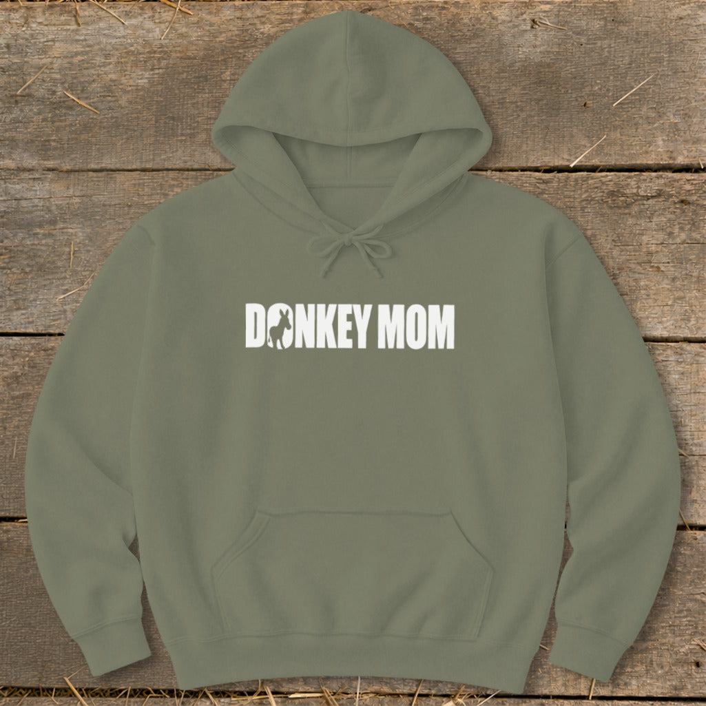 Olive green hooded sweatshirt with white Donkey Mom text and donkey silhouette on a rustic wooden background.