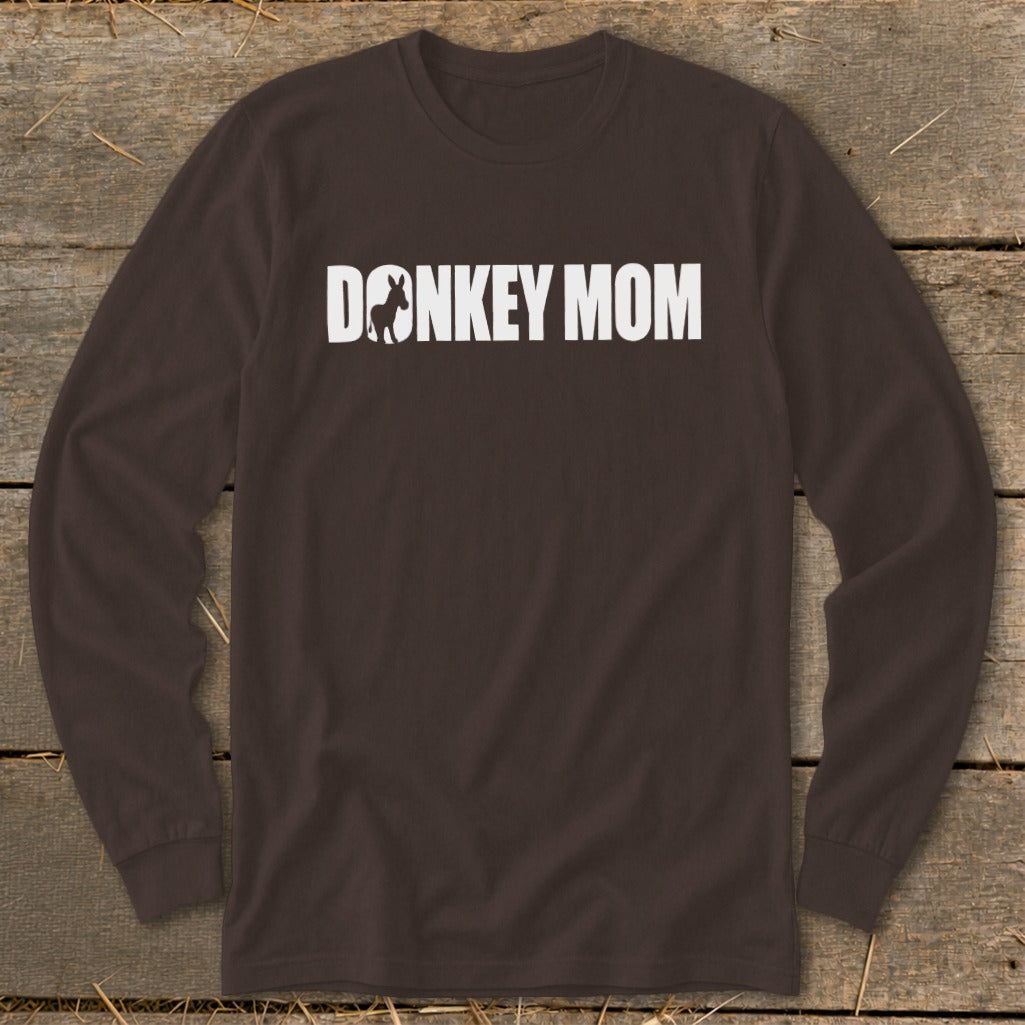 A dark brown long-sleeve t-shirt with white text that reads DONKEY MOM, featuring a donkey silhouette inside the letter O.