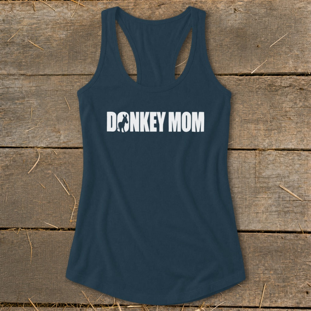 Dark blue racerback tank top with white Donkey Mom text centered on a wooden background.