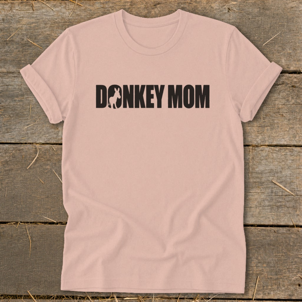 Dusty pink short-sleeve crewneck t-shirt with black text reading Donkey Mom centered on the chest.