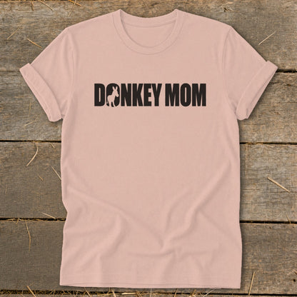 Dusty pink short-sleeve crewneck t-shirt with black text reading Donkey Mom centered on the chest.