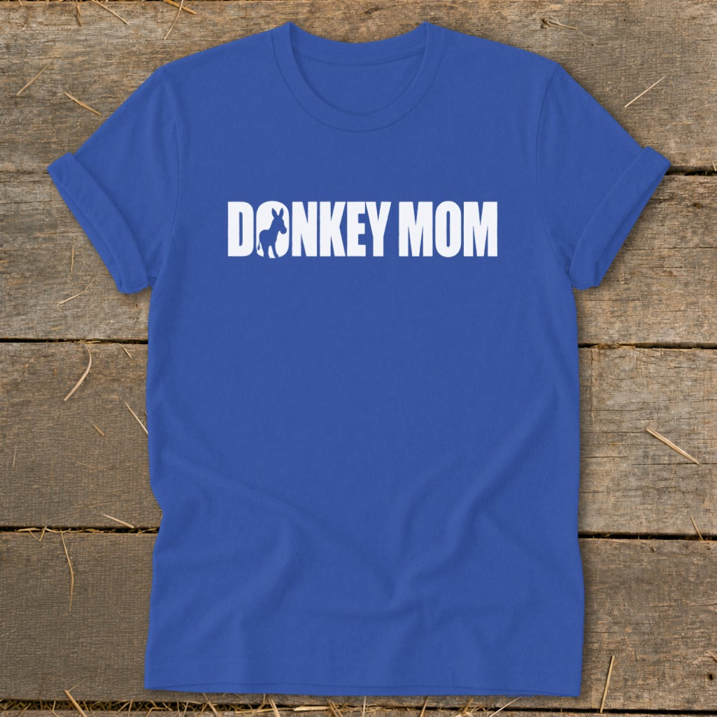 Royal blue crewneck t-shirt featuring the white text DONKEY MOM with a donkey silhouette on a rustic wooden background.
