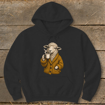 Black hooded sweatshirt featuring a graphic of a sheep wearing a yellow cardigan while drinking coffee.