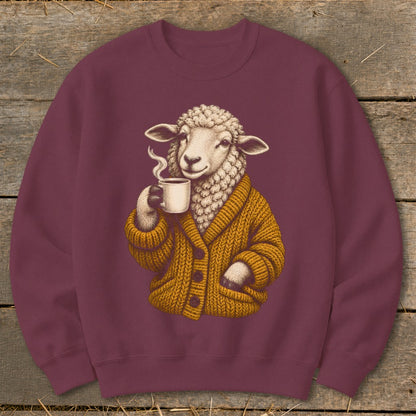 Maroon crewneck sweatshirt featuring a graphic of a sheep wearing a mustard-yellow cardigan and drinking coffee.