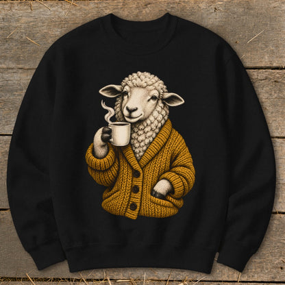 A black crewneck sweatshirt printed with a sheep in a yellow cardigan holding a steaming mug.
