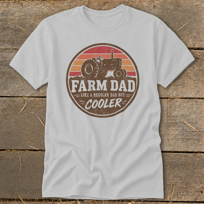Light gray t-shirt with a round retro graphic featuring a tractor and text reading Farm Dad Like A Regular Dad But Cooler.